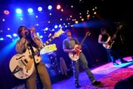 Axel Ellis, William Lipton, and Jesse Golliher perform onstage during The Runarounds Red Carpet Premiere and After Party at The Roxy (Image via Getty)